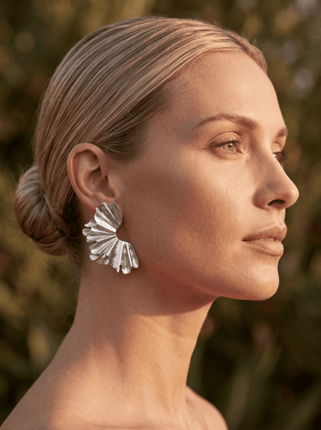 Silver earrings from AUKA STUDIO jewelry collection featuring sleek, modern design with polished silver finish.