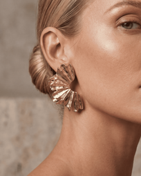 Gold earrings from AUKA STUDIO's RITT collection featuring sleek, modern design with a polished finish.