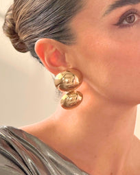 A pair of gold BAZEL earrings by AUKA STUDIO featuring sleek, modern jewelry design with a polished finish.