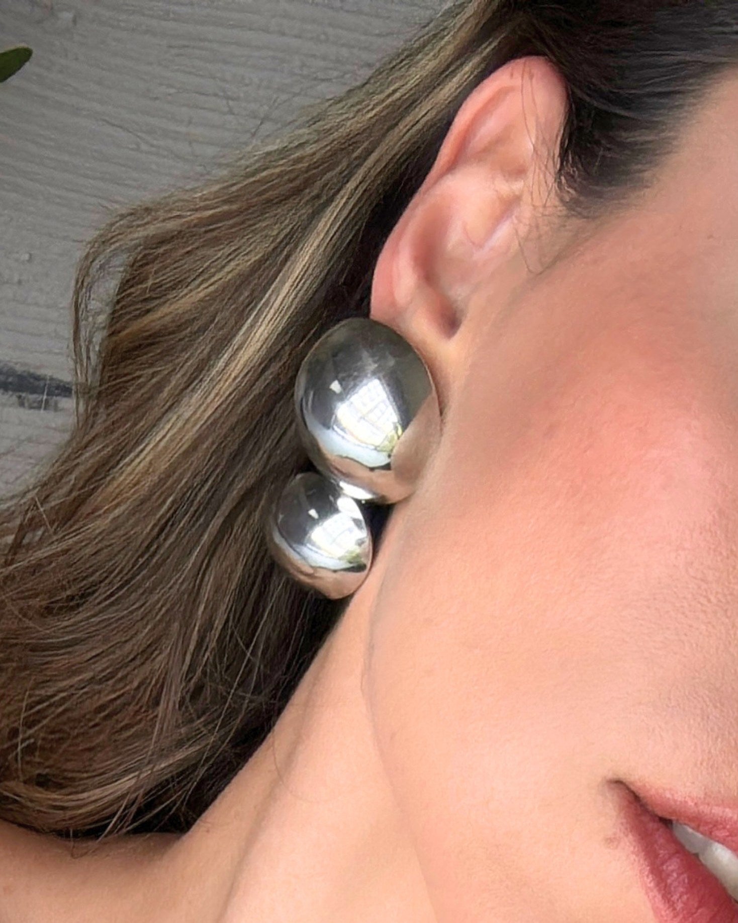 Silver BAZEL earrings by AUKA STUDIO, showcasing sleek, modern jewelry design with a polished finish and elegant shape.